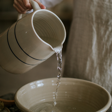 Stoneware jugs pouring in a kitchen - handmade in the USA by Martinez pottery - classic country styling and made to last a lifetime