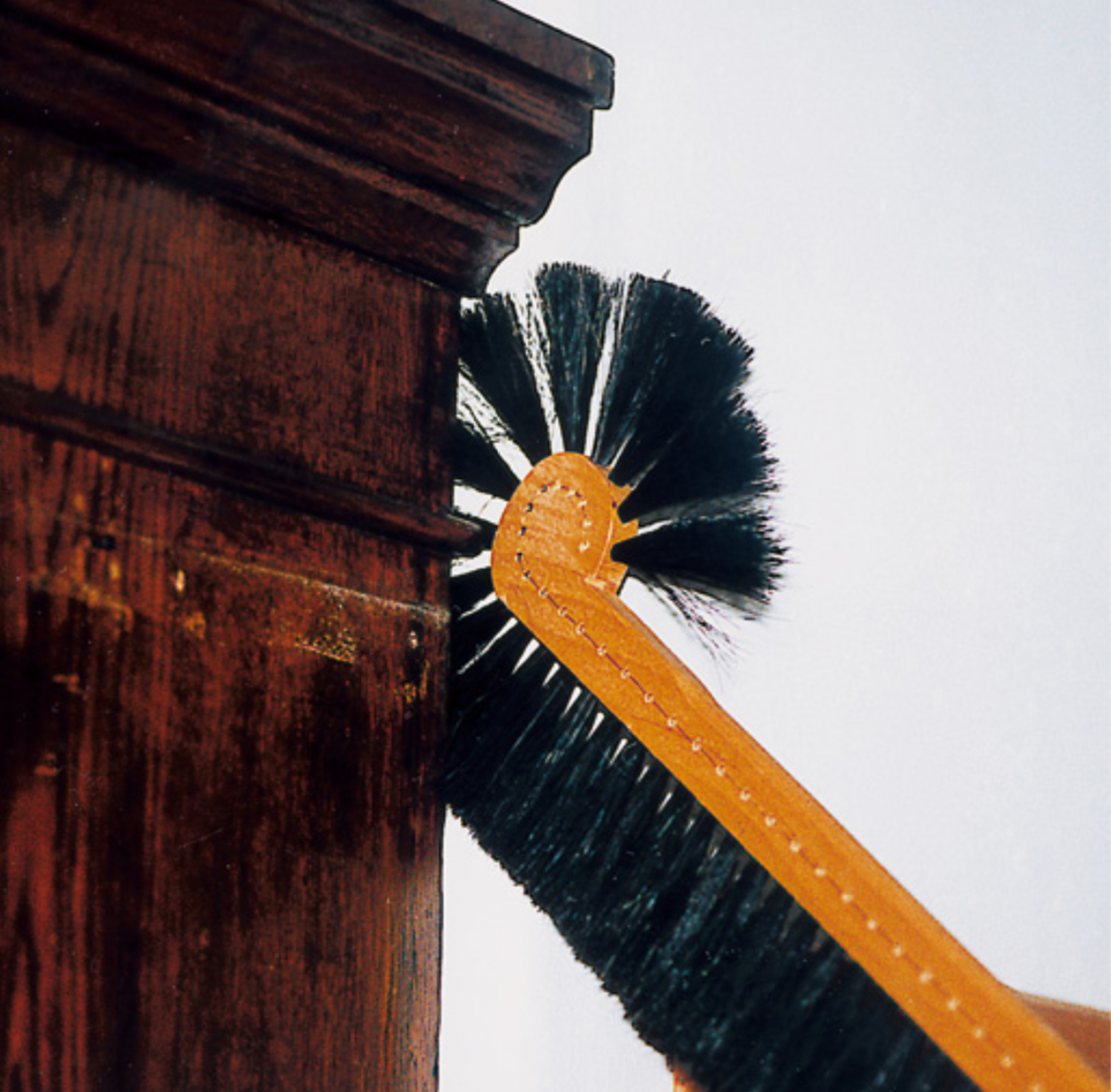 Behind the cabinet brush