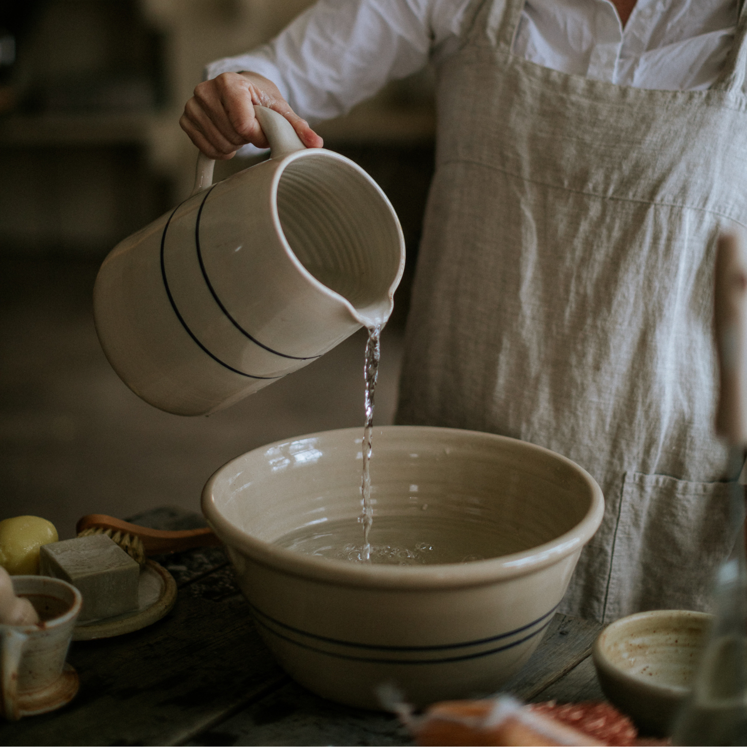 Stoneware jugs pouring in a kitchen -  handmade in the USA by Martinez pottery - classic country styling and made to last a lifetime