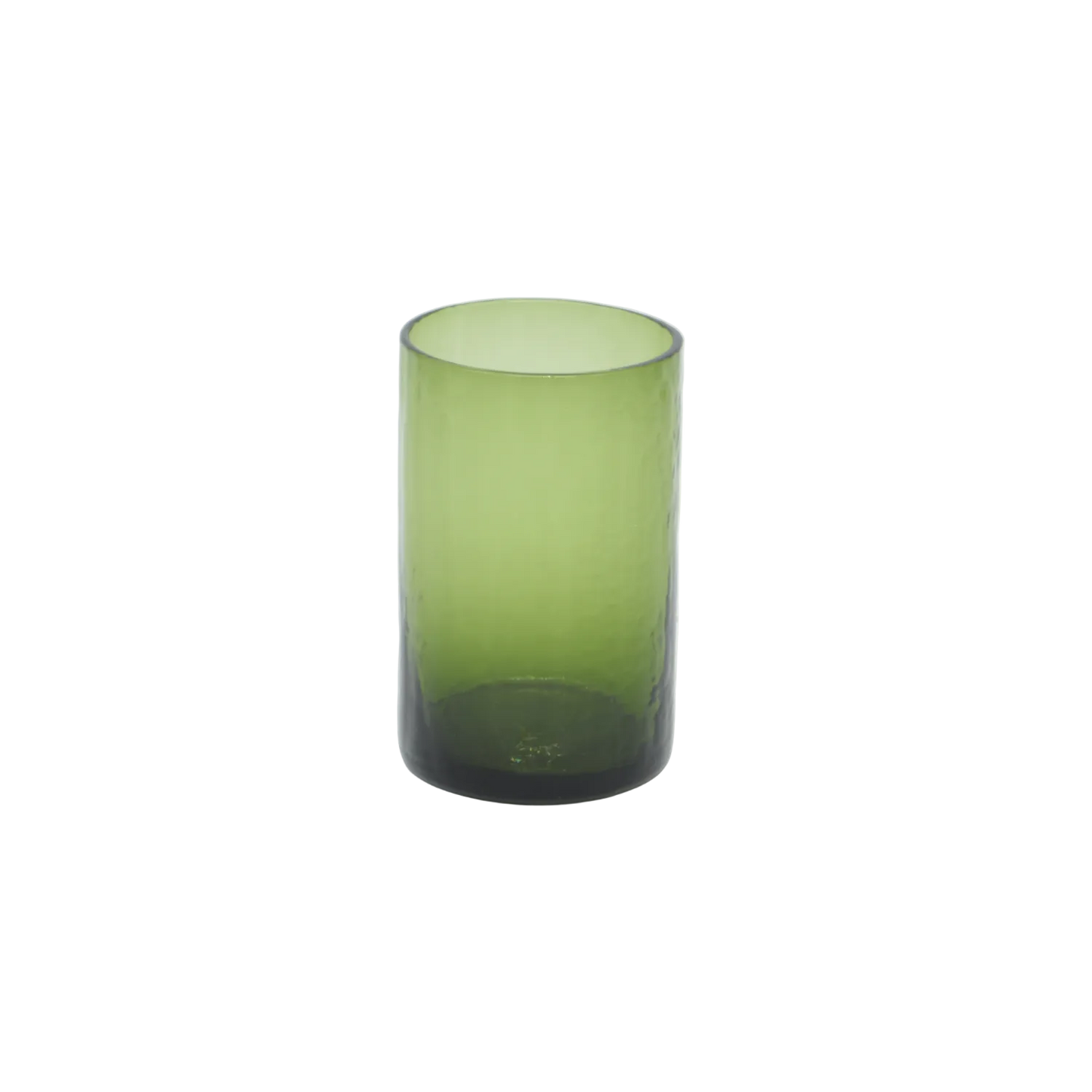 Green glass tumbler on a white background