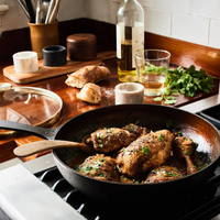 Smithey cast iron no. 11 pan with lid cooking chicken